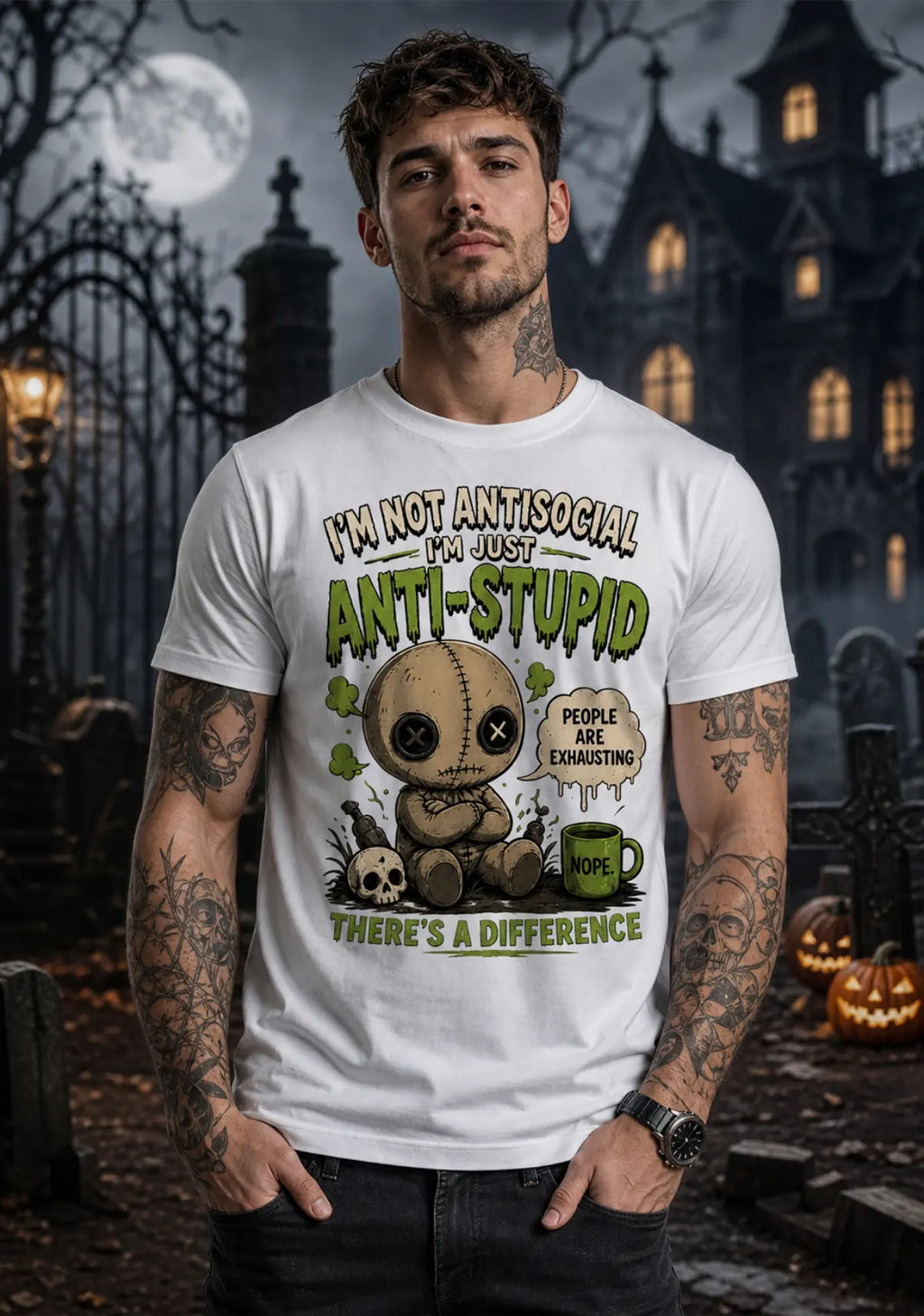Person wearing a chibi voodoo doll anti‑stupid T‑shirt in a spooky Halloween setting with pumpkins and a gothic building