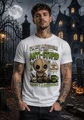 Person wearing a chibi voodoo doll anti‑stupid T‑shirt in a spooky Halloween setting with pumpkins and a gothic building