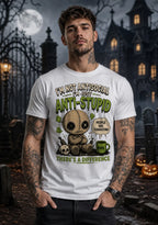 Person wearing a chibi voodoo doll anti‑stupid T‑shirt in a spooky Halloween setting with pumpkins and a gothic building