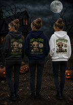 Three people wearing anti‑stupid voodoo doll hoodies in a spooky Halloween scene with a gothic house, full moon and glowing pumpkins