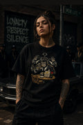Person wearing The Ape Father funny gorilla mob boss tee sitting at a café table in a noir‑style scene with dark humour vibes