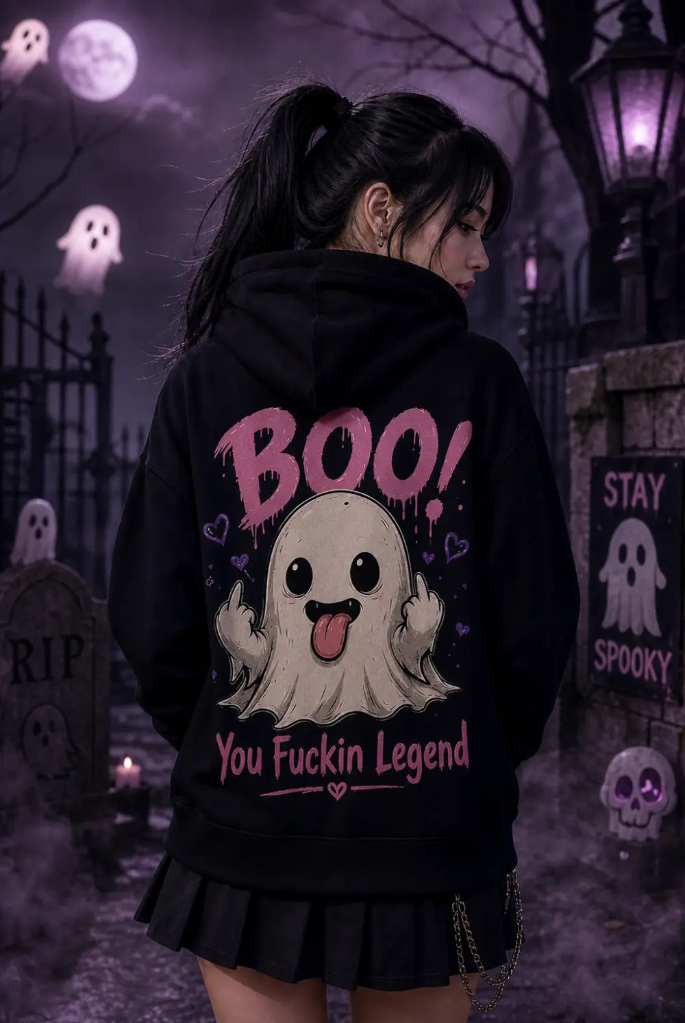 Person in black hoodie with playful ghost graphic standing in eerie moonlit graveyard scene with floating ghosts and purple lantern glow