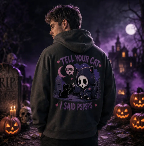 Person in Halloween graveyard scene wearing dark hoodie, standing amid pumpkins, tombstones, skulls and eerie purple moonlit mist