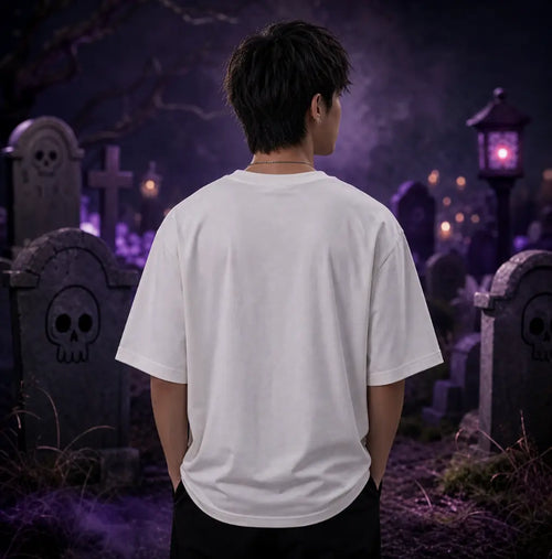 Person facing away in moonlit graveyard wearing white tee, standing amid tombstones, purple lantern glow and eerie misty atmosphere