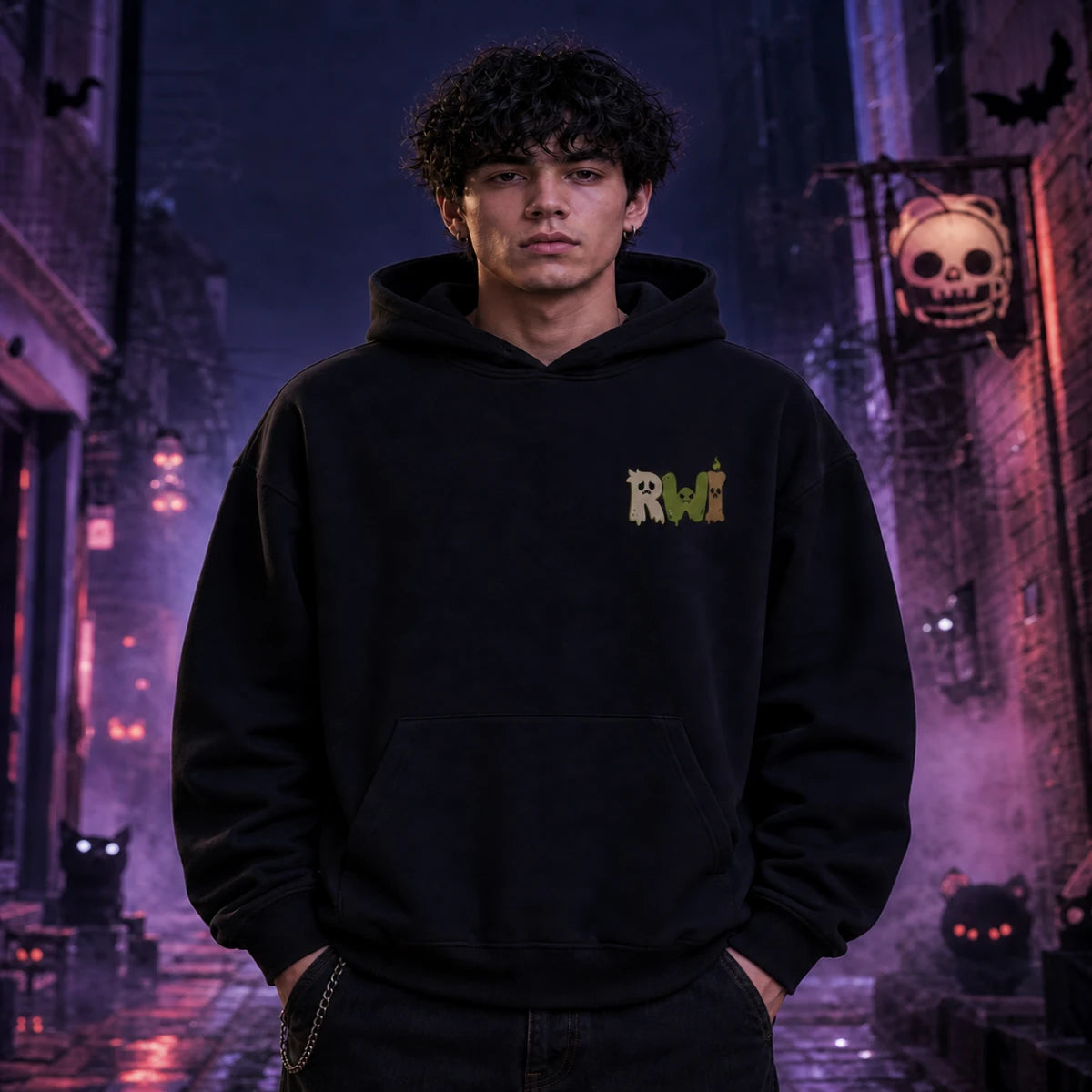 Person in black RWI hoodie standing in a foggy Halloween alley with glowing jack‑o’-lanterns, bats, and eerie orange lighting.