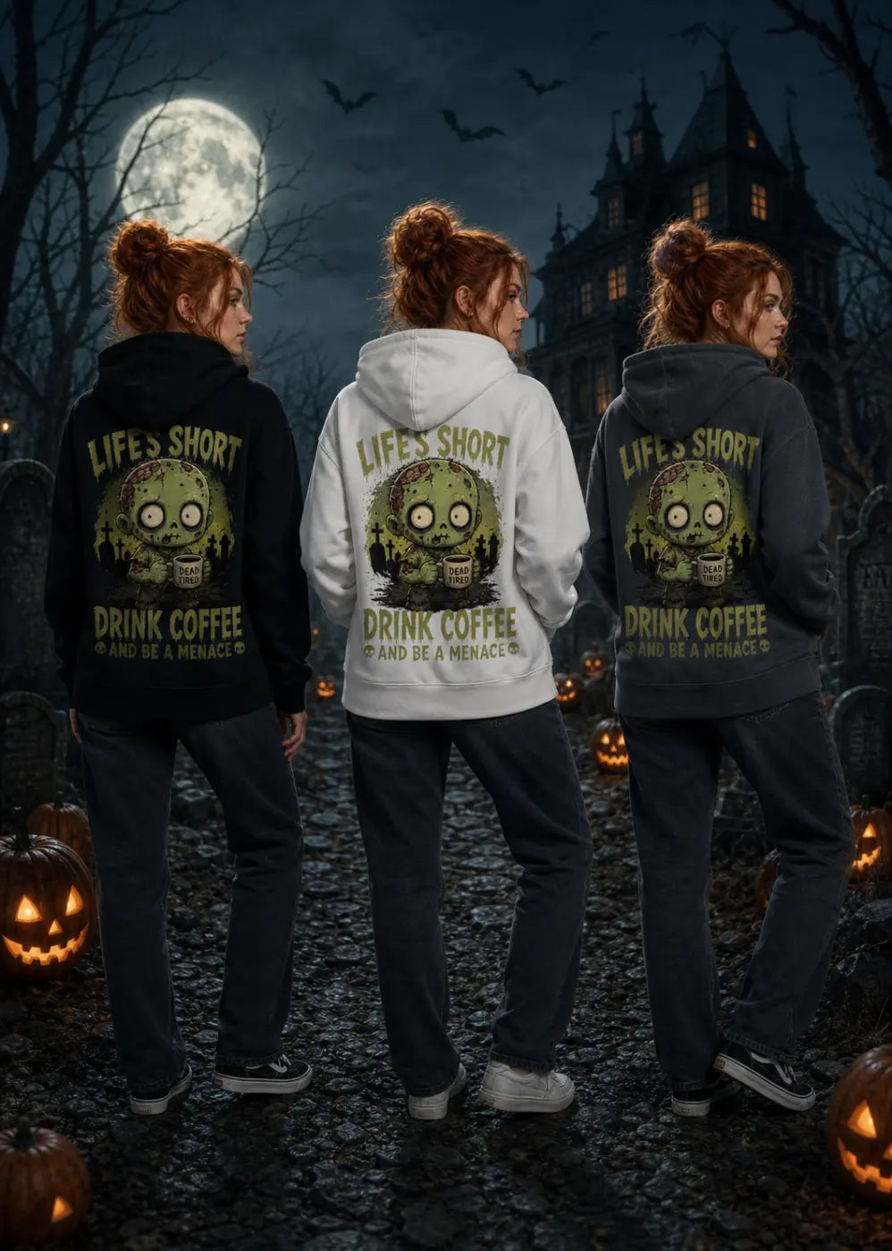 Three women stand in a moonlit graveyard wearing hoodies with zombie graphics and “Life’s Short Drink Coffee” text.