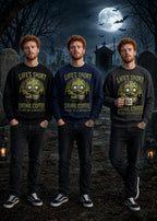 Three men stand in a moonlit graveyard wearing black, blue & grey sweatshirts with zombie graphics and “Life’s Short Drink Coffee” text.