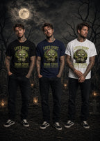 Three men stand in a moonlit graveyard wearing black, navy, and white T‑shirts with zombie graphics and coffee text.