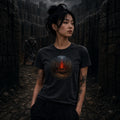 Person in black tee stands in dark stone labyrinth as horned axe‑wielding creature looms behind amid bones and shadows