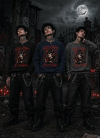 Three people in gothic scene wearing chibi horror sweatshirts, standing before moonlit gates, red candles, skulls and bats