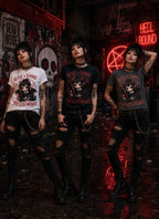 Three people in grungy alley wearing chibi horror tees, standing amid red neon signs, graffiti skull art and dark punk décor