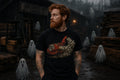 A man with red hair and a beard stands in a dark, foggy lumber yard wearing a black graphic t‑shirt featuring a red wood chipper dumping a pile of small white ghostly figures.