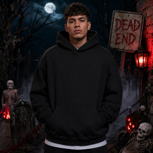 Person wearing a black hoodie in a spooky graveyard scene with skeletons, fog, full moon, tombstones and a red lantern glow