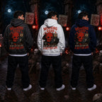 Three people wearing cat‑lover devil hoodies in a spooky graveyard scene with skeletons, tombstones, fog and red lantern light